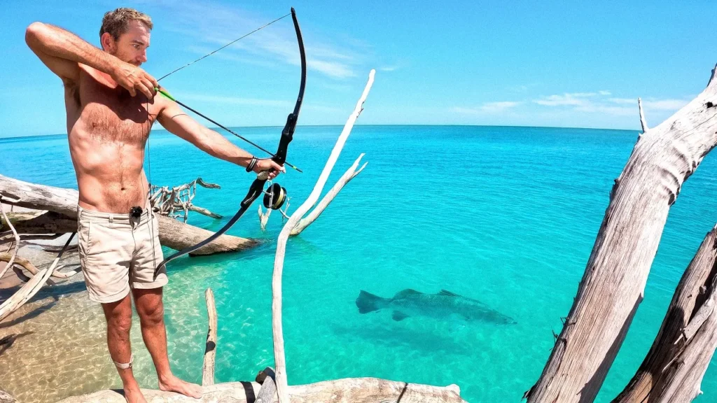 Back 2 Basics host bow fishing beside turquoise water