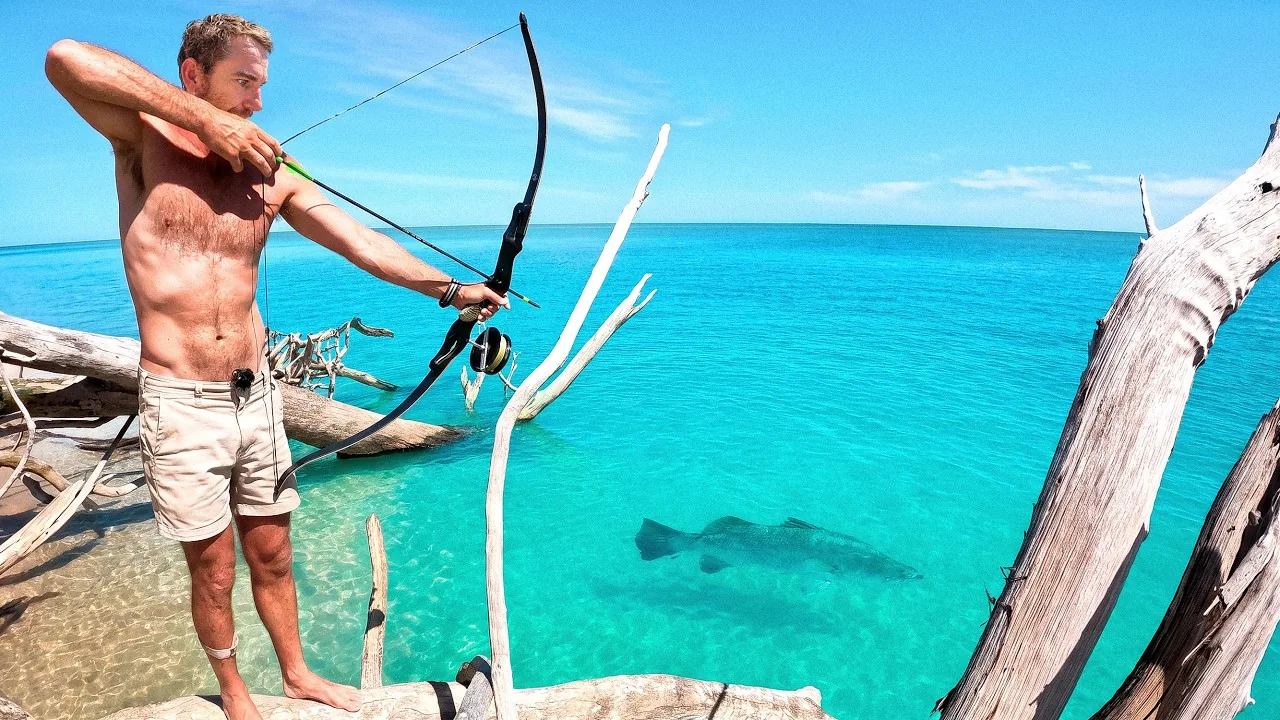 Back 2 Basics host bow fishing beside turquoise water
