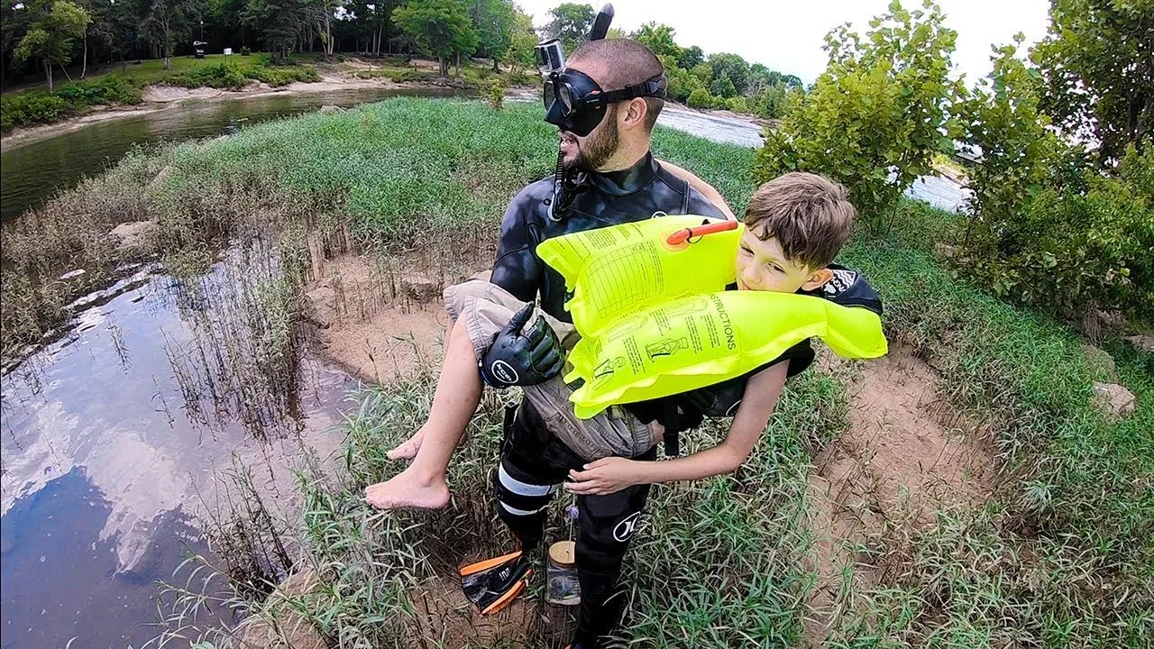 Jiggin With Jordan preparing diving equipment beside the water