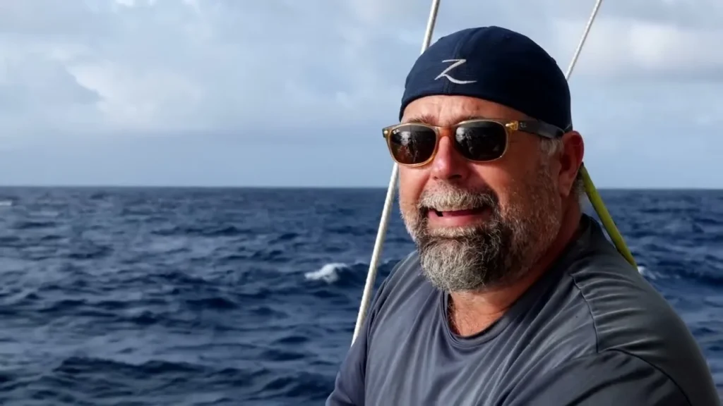 Keith of Sailing Zatara at sea aboard the family sailboat