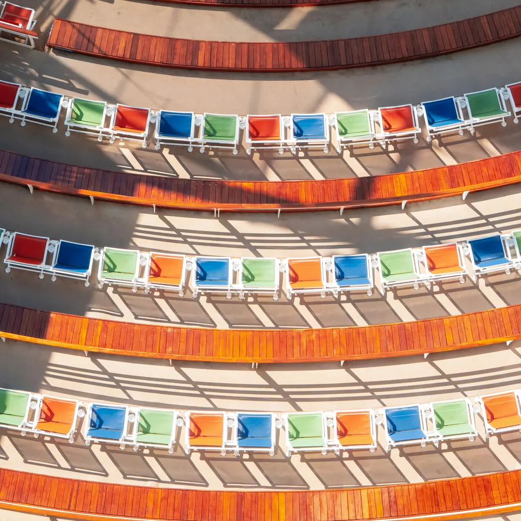Empty tiered seats and a lit stage in a cruise ship theater