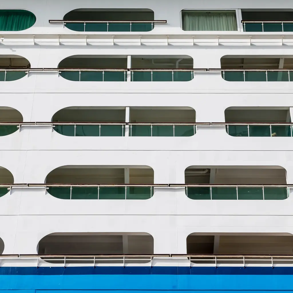 Balcony openings cut into a cruise ship's hull just above the waterline