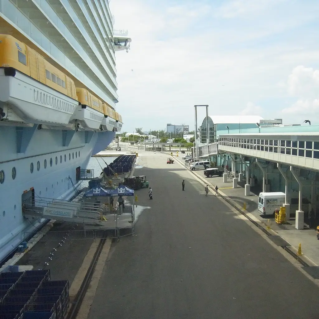 A gangway linking a low deck of a large cruise ship to the pier