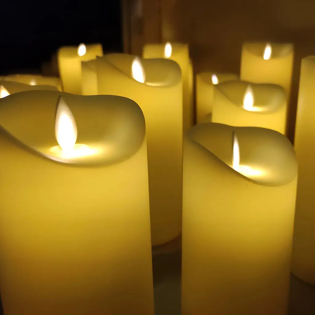 Flameless LED candles glowing in a dim room