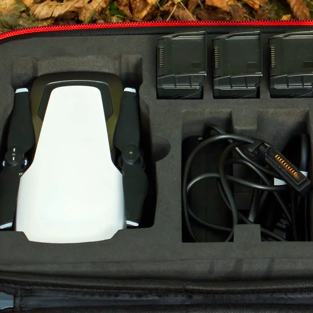 A folded camera drone packed in a fitted travel case