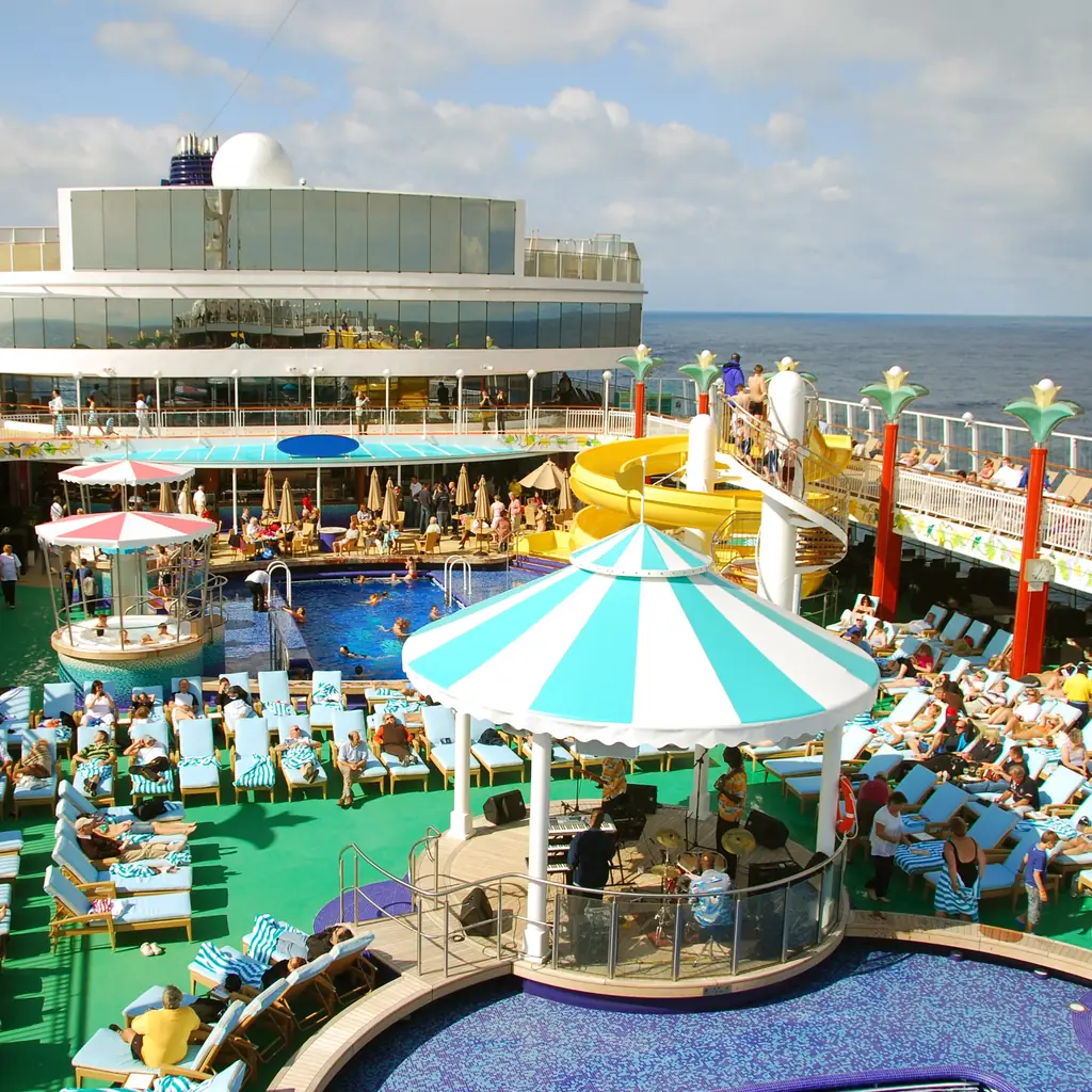 The busy pool deck of a large cruise ship on a sunny day