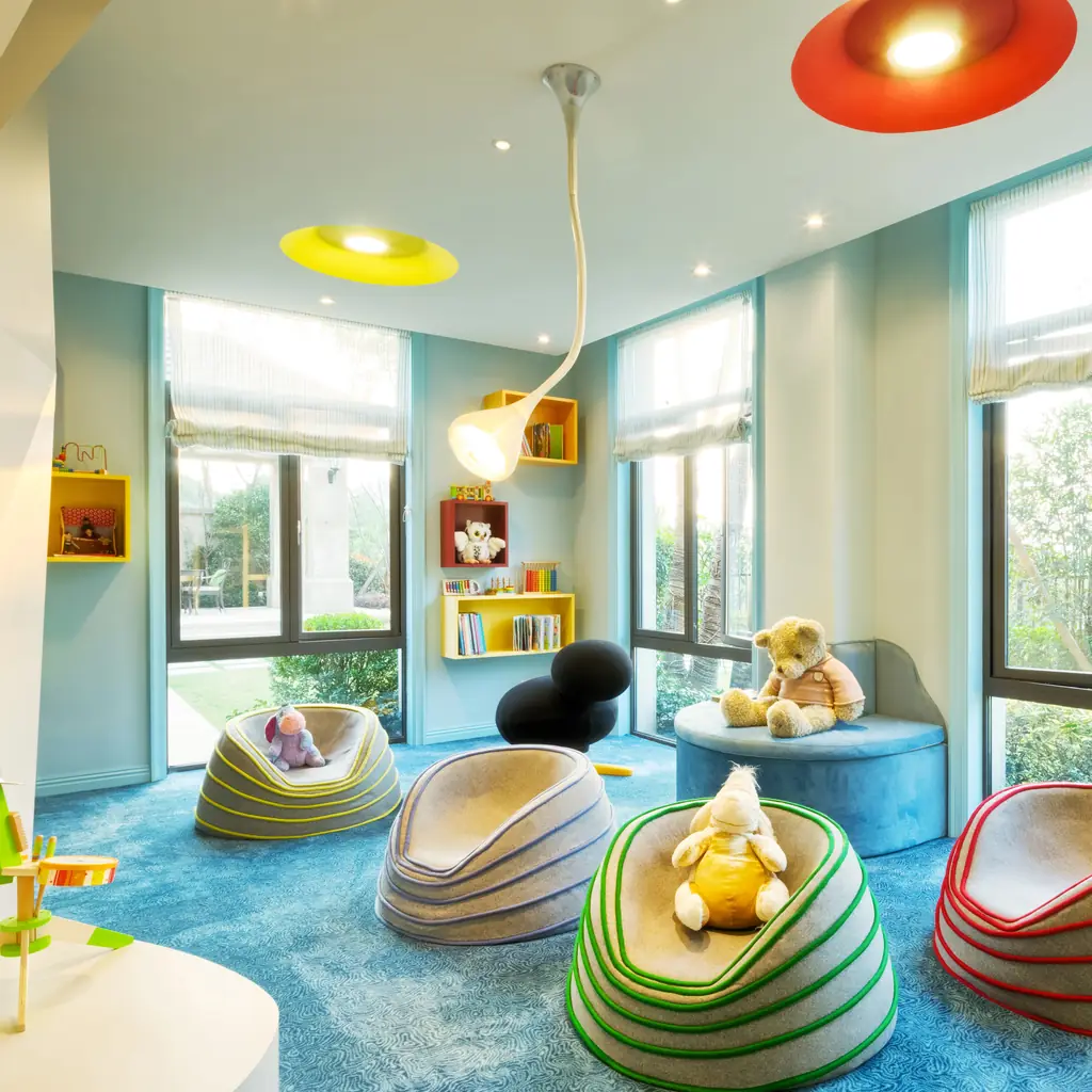 A bright children's playroom with bean bags and toys