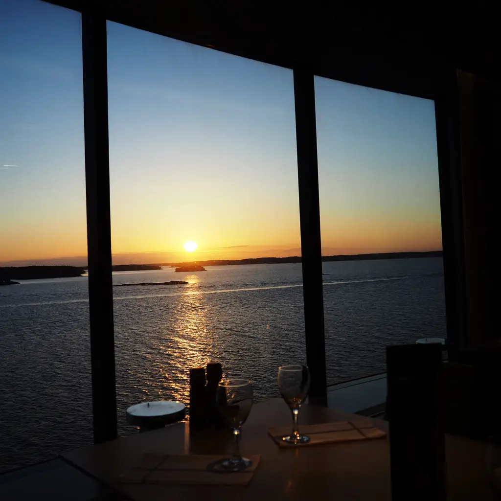 A window table at sunset with the sea outside