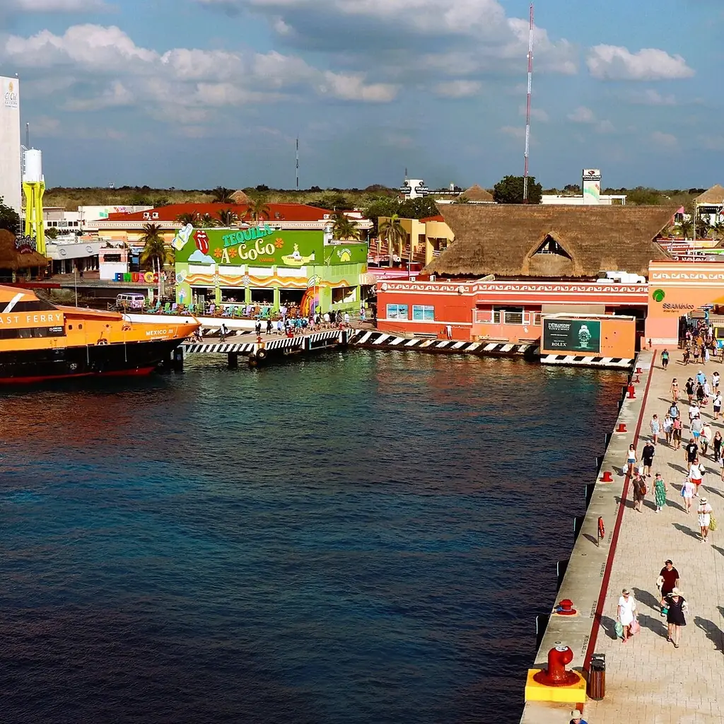 Passengers walking along the long cruise pier in Cozumel, Mexico