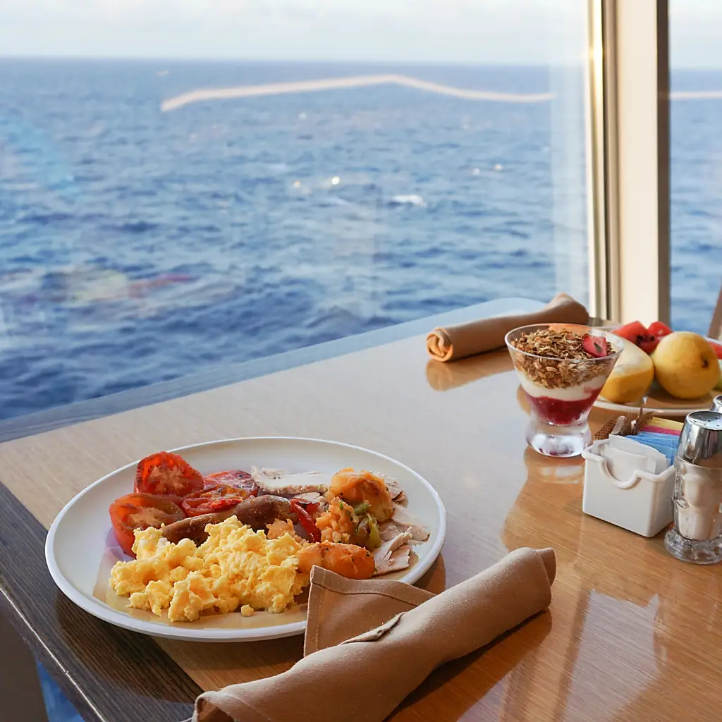 A served breakfast beside a sea-view window on a cruise ship
