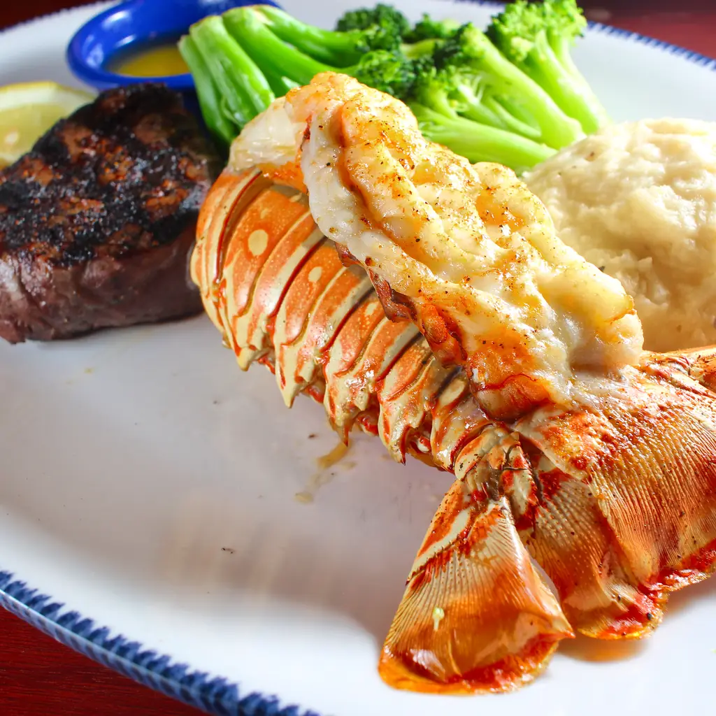 A lobster tail and filet dinner with drawn butter