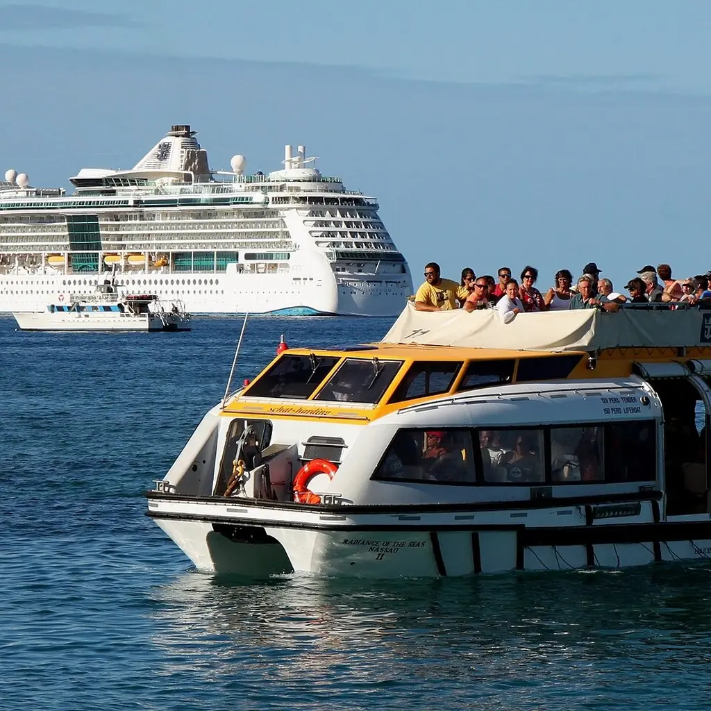 A tender boat ferrying passengers ashore from a cruise ship anchored off Lahaina, Maui