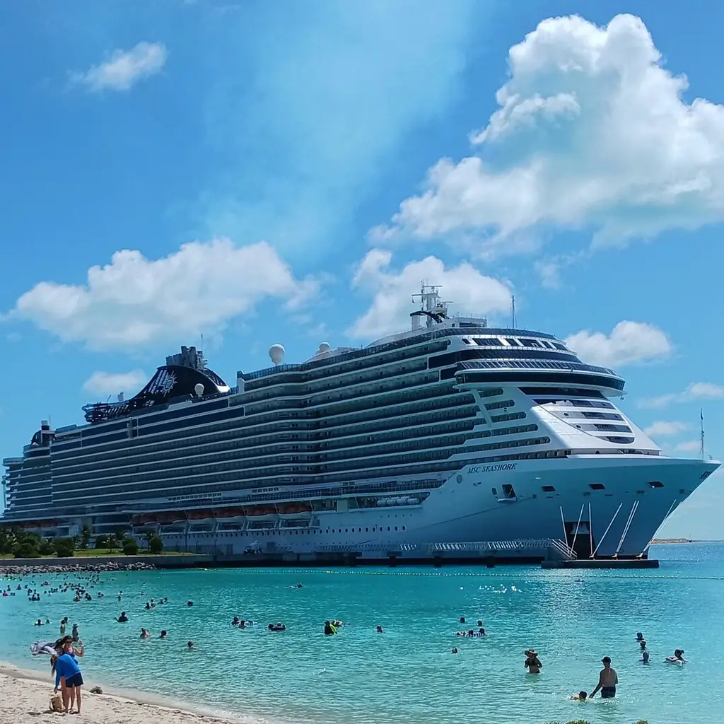 An MSC Cruises ship docked at a port on a clear day