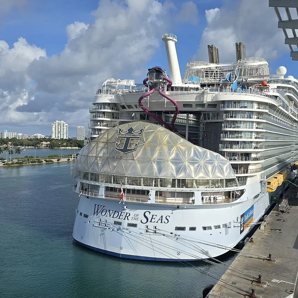 A Royal Caribbean Oasis-class ship docked at a cruise terminal