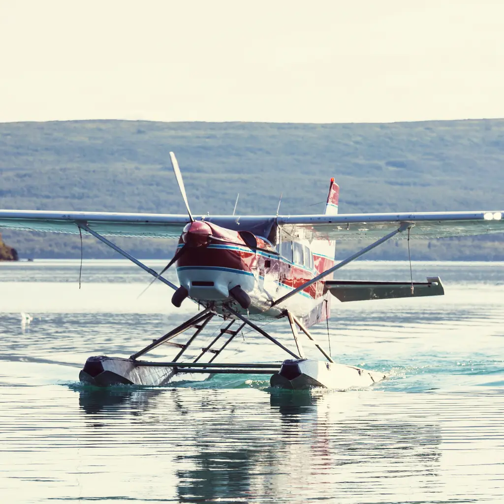 A floatplane on the water in Alaska, the kind of small aircraft used for flightseeing tours from Ketchikan or Juneau.