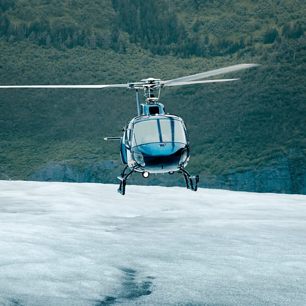 A tour helicopter landed on glacier ice, the kind of landing experience floatplanes generally cannot offer.