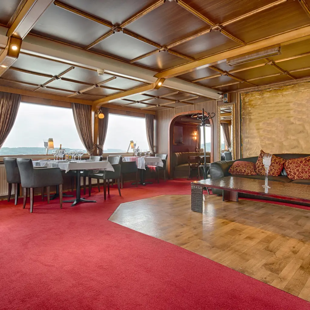 A cruise ship fine-dining restaurant interior, the kind of suite-exclusive venue included at higher cabin tiers on some lines.