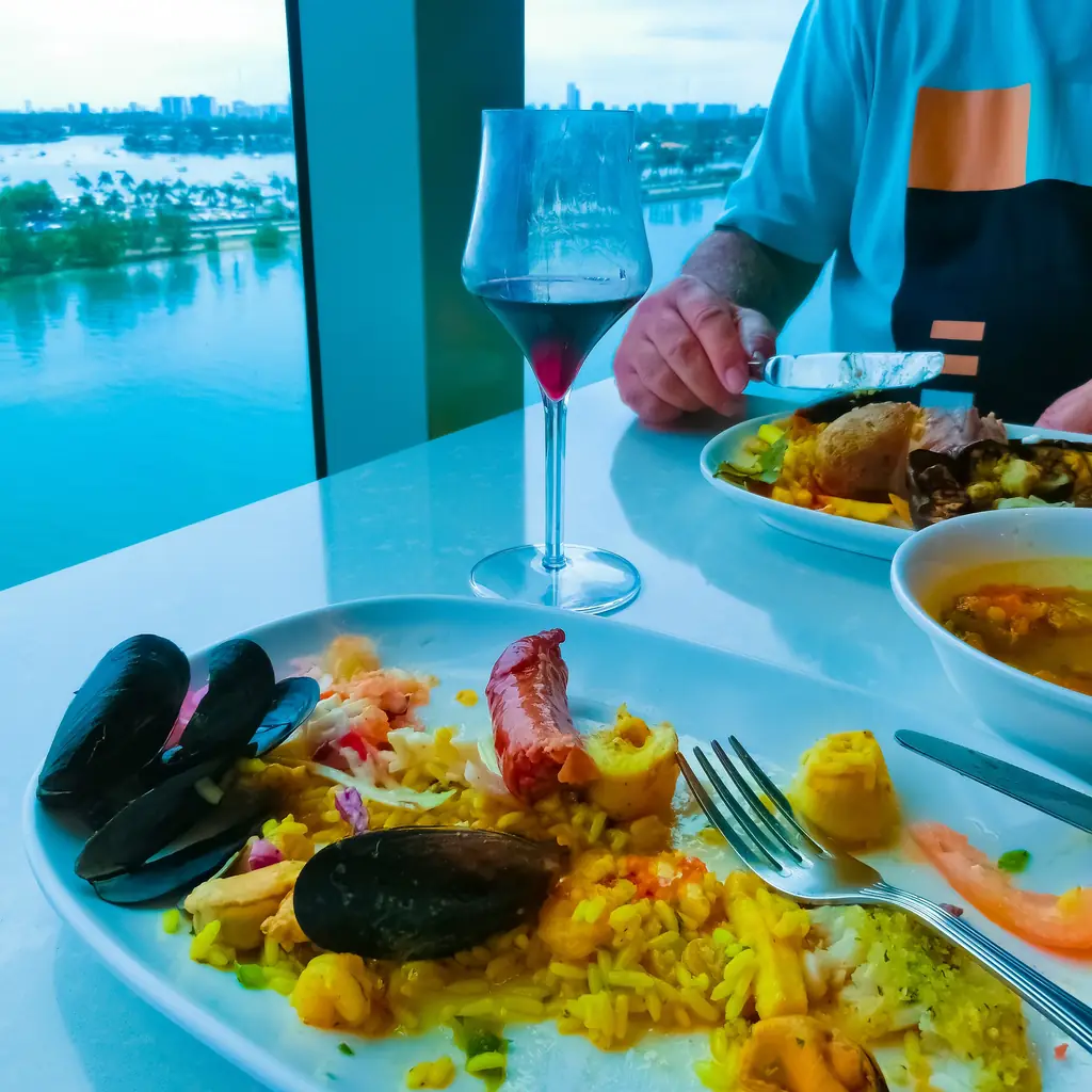 A plated seafood dish at a cruise ship specialty restaurant, the kind of venue included in a per-day dining package.