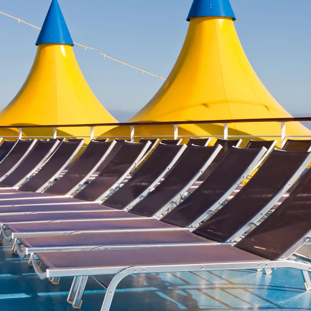 An outdoor relaxation area near the stern of a cruise ship, the kind of space included with a spa-category stateroom.