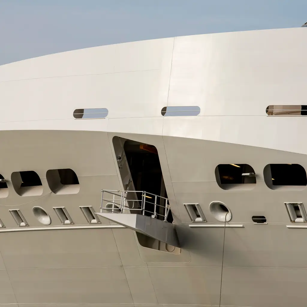 A cruise ship's gangway and mooring platform at port, where priority embarkation lets suite and top-tier guests board first.