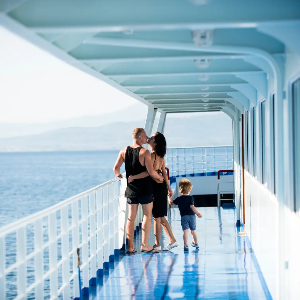A family with a young child on a cruise ship deck, illustrating multi-generational travel considerations for Alaska-specific add-ons.